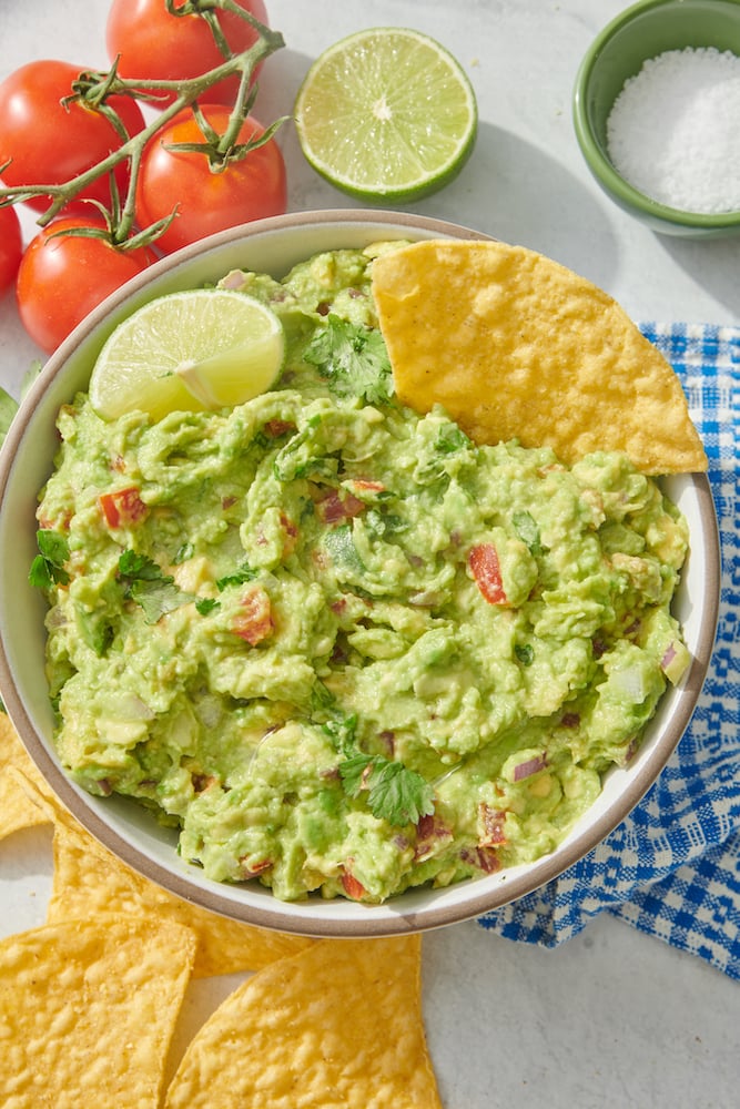 guacamole in serving bowl with lime