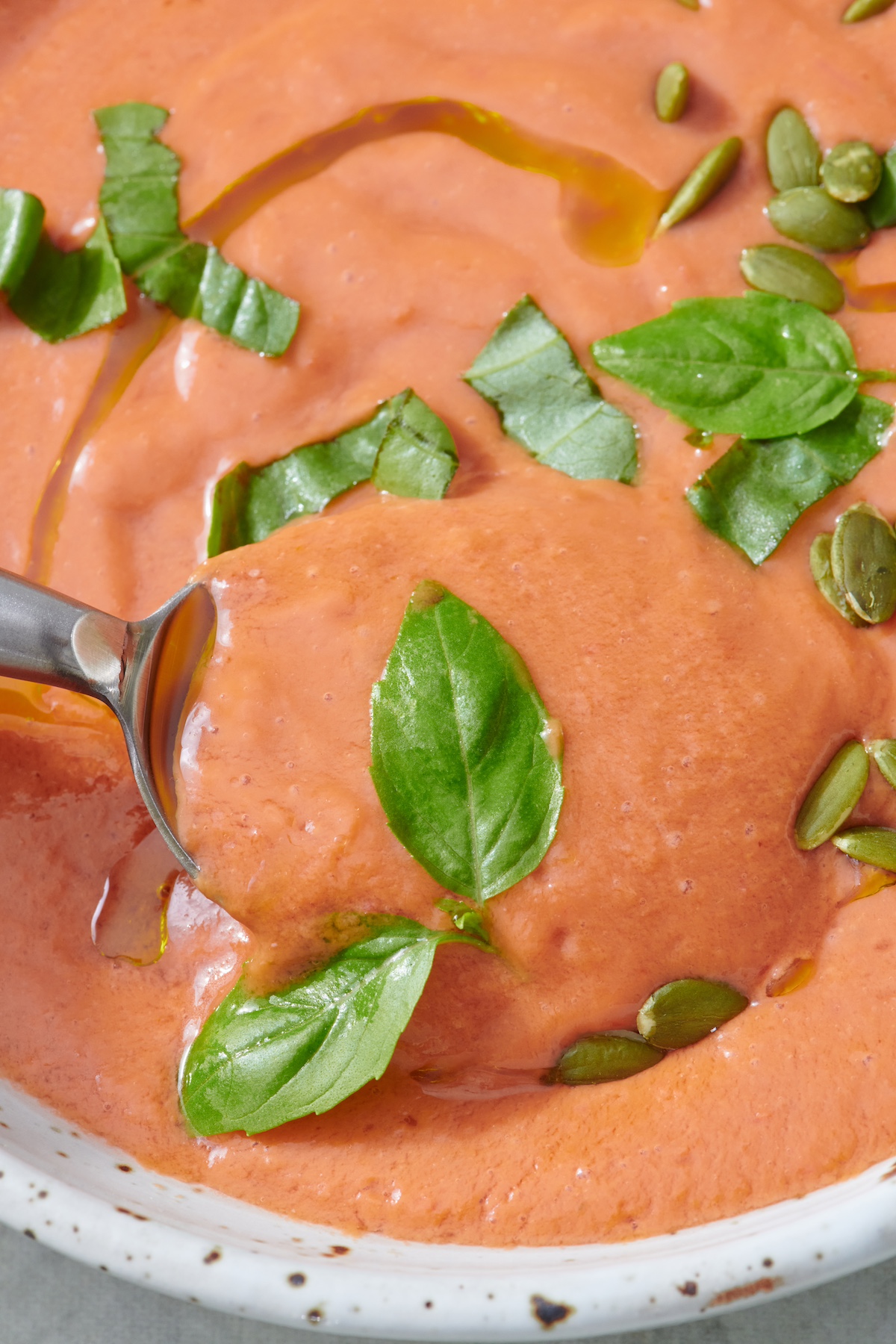 Quick and Easy Gazpacho topped with fresh basil.