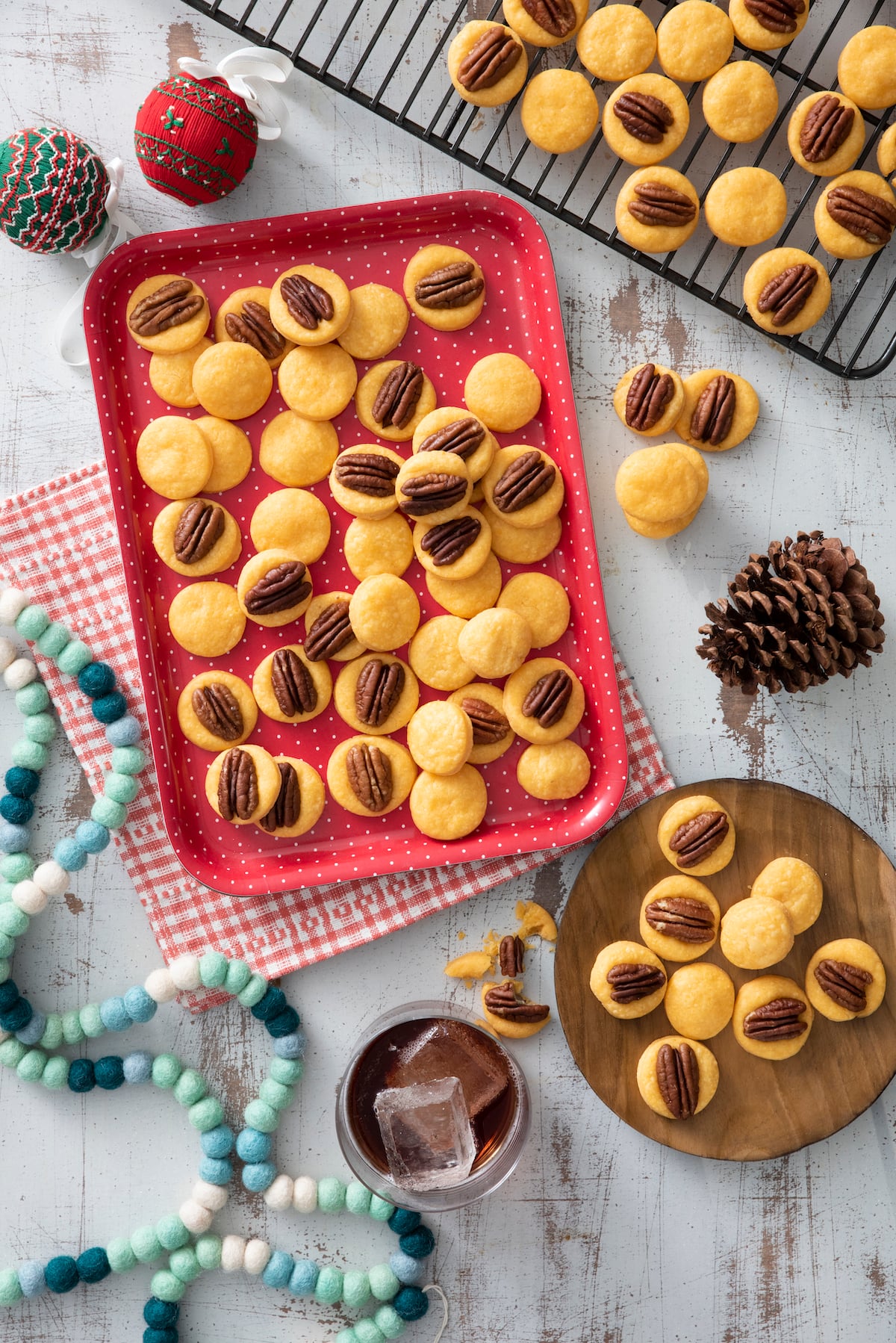 Cheese wafers topped with pecan halves on serving platter.
