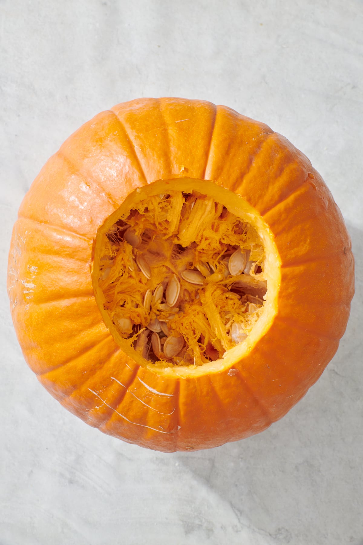 Pumpkin with top missing revealing inside flesh.