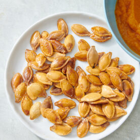 Toasted pumpkin seeds on a plate.