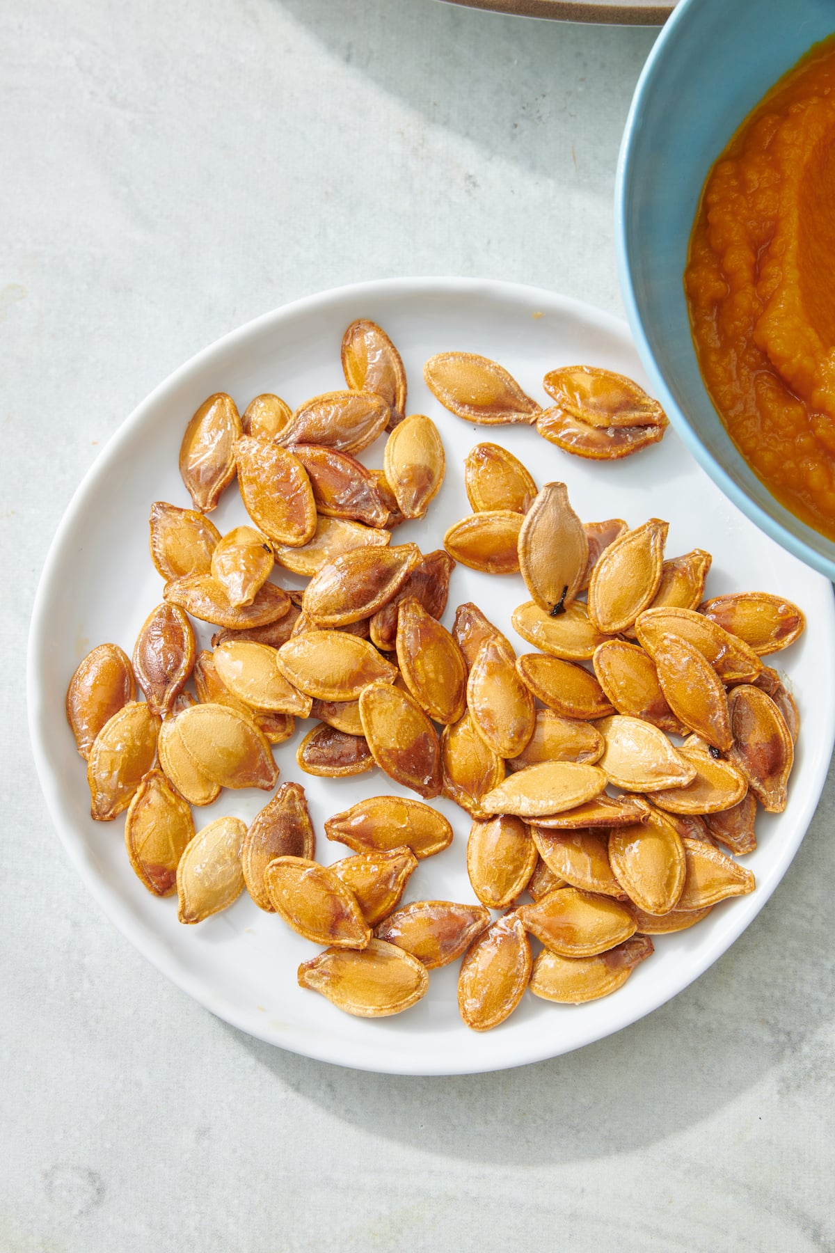 Toasted pumpkin seeds on a plate.