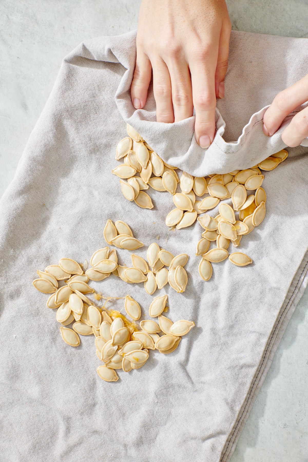 Drying pumpkin seeds with hand towel.