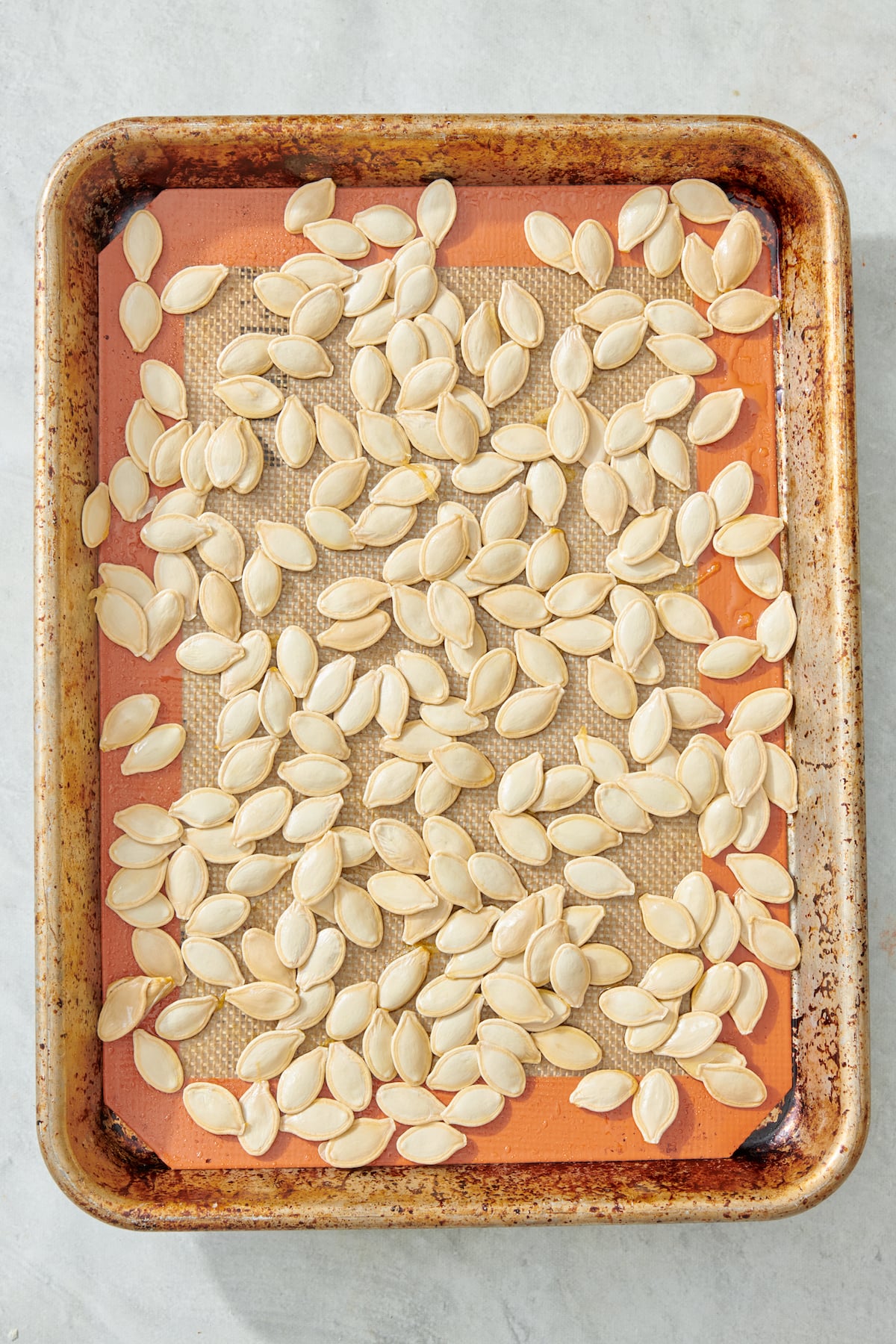 Pumpkin seeds on baking sheet.