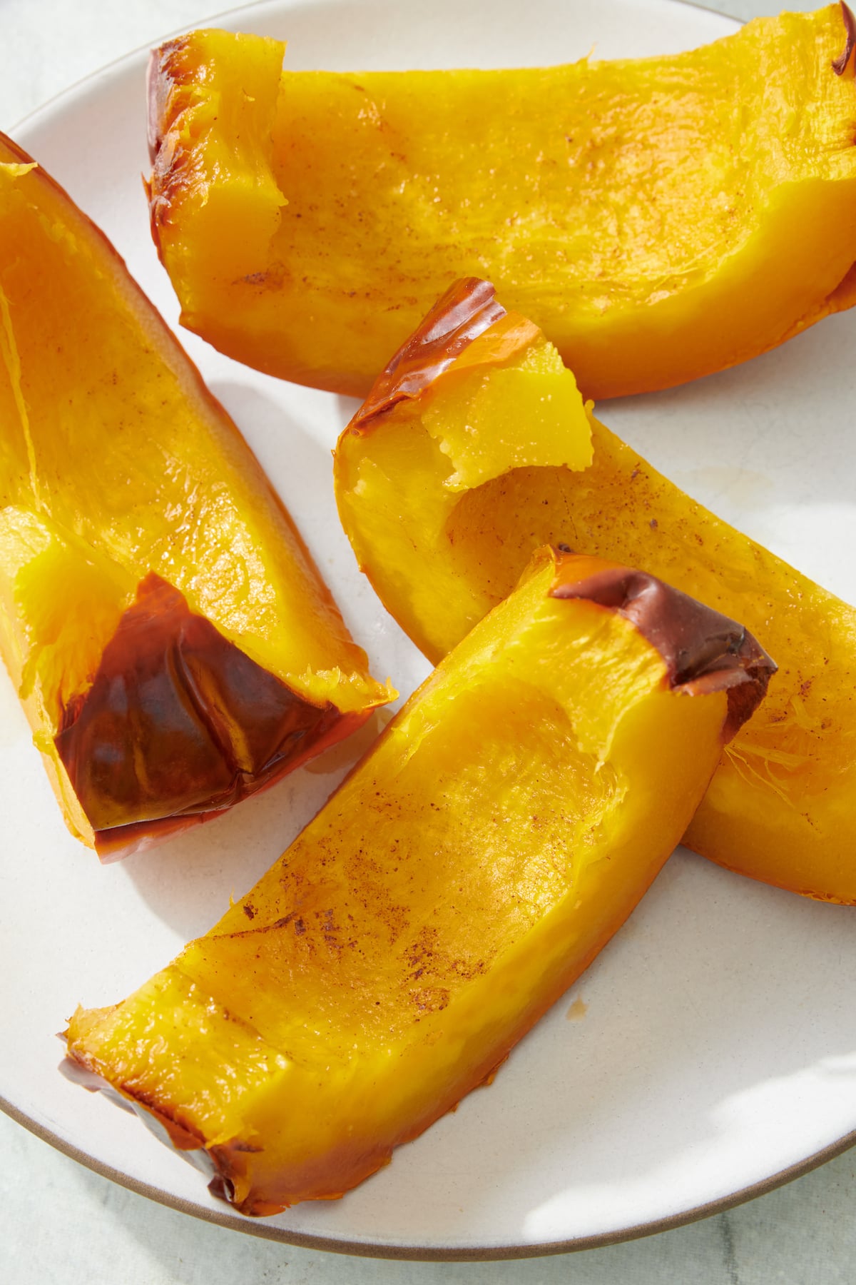 Slices of roast pumpkin on plate.