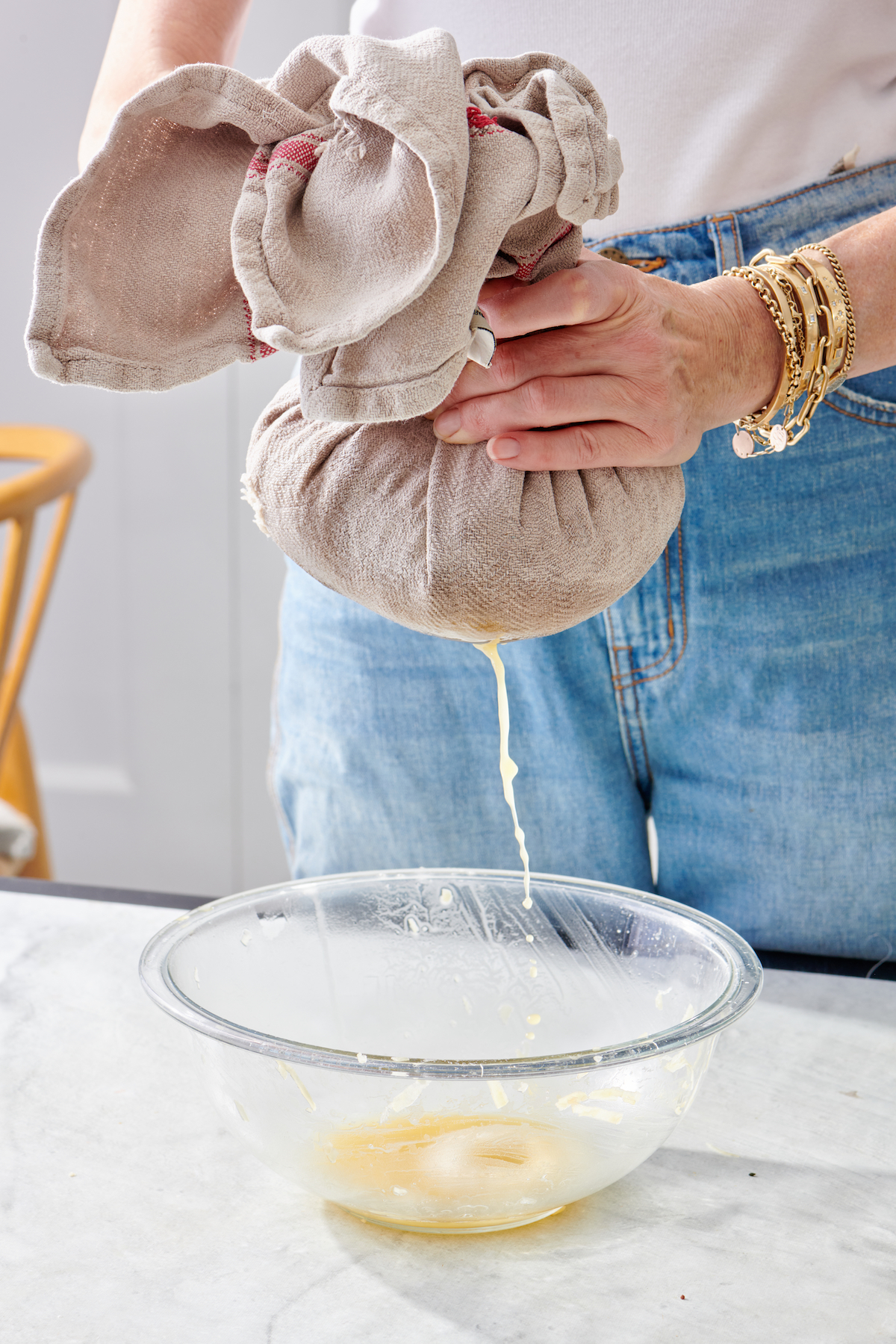 Squeezing excess liquid from grated potatoes.