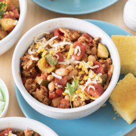 Turkey veggie chili in a bowl served with cornbread.
