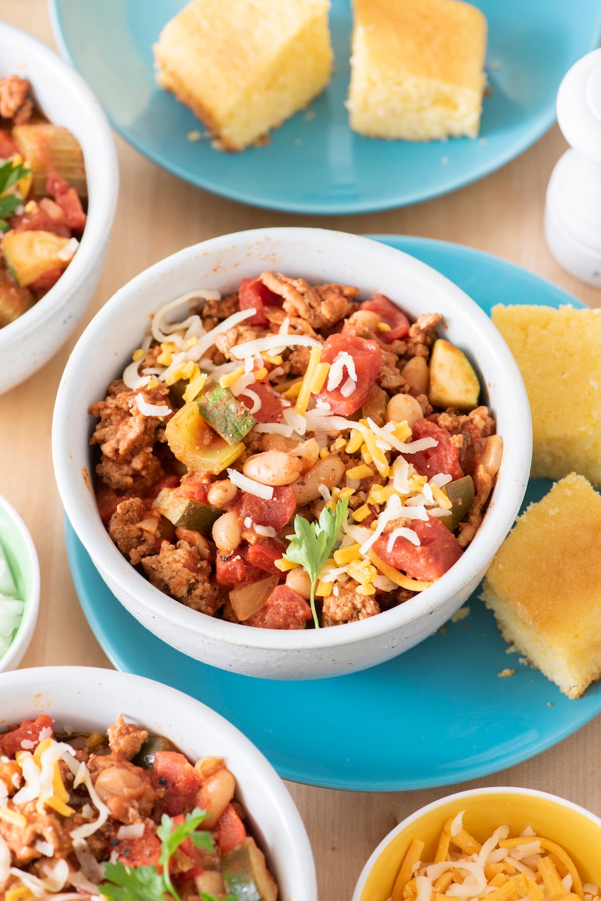 Turkey veggie chili in a bowl served with cornbread.