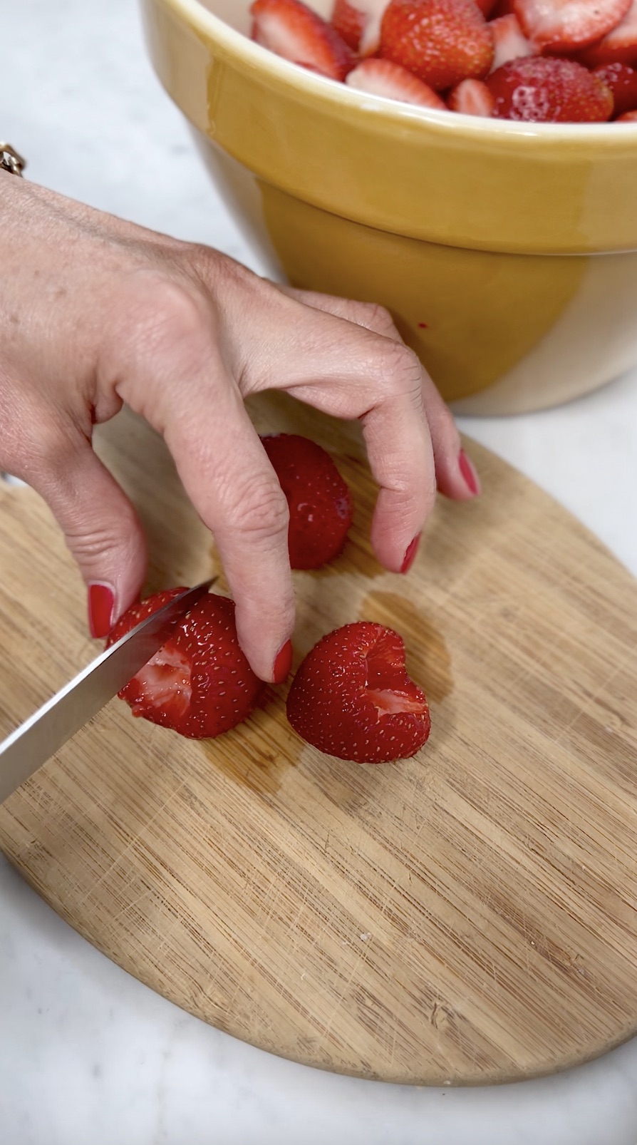 Prepping strawberries for preserve.