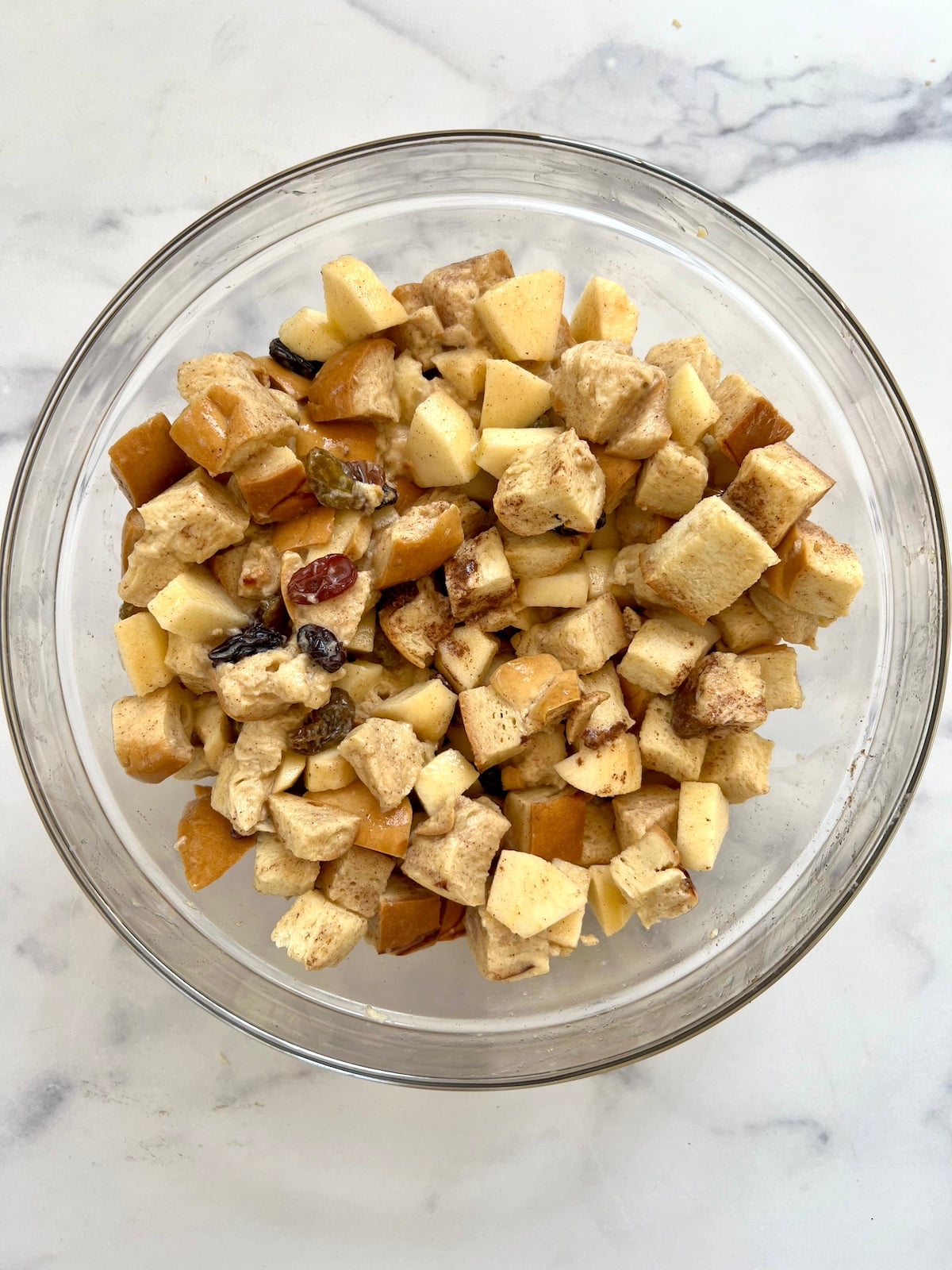 Breakfast bread pudding ingredients combined in mixing bowl.