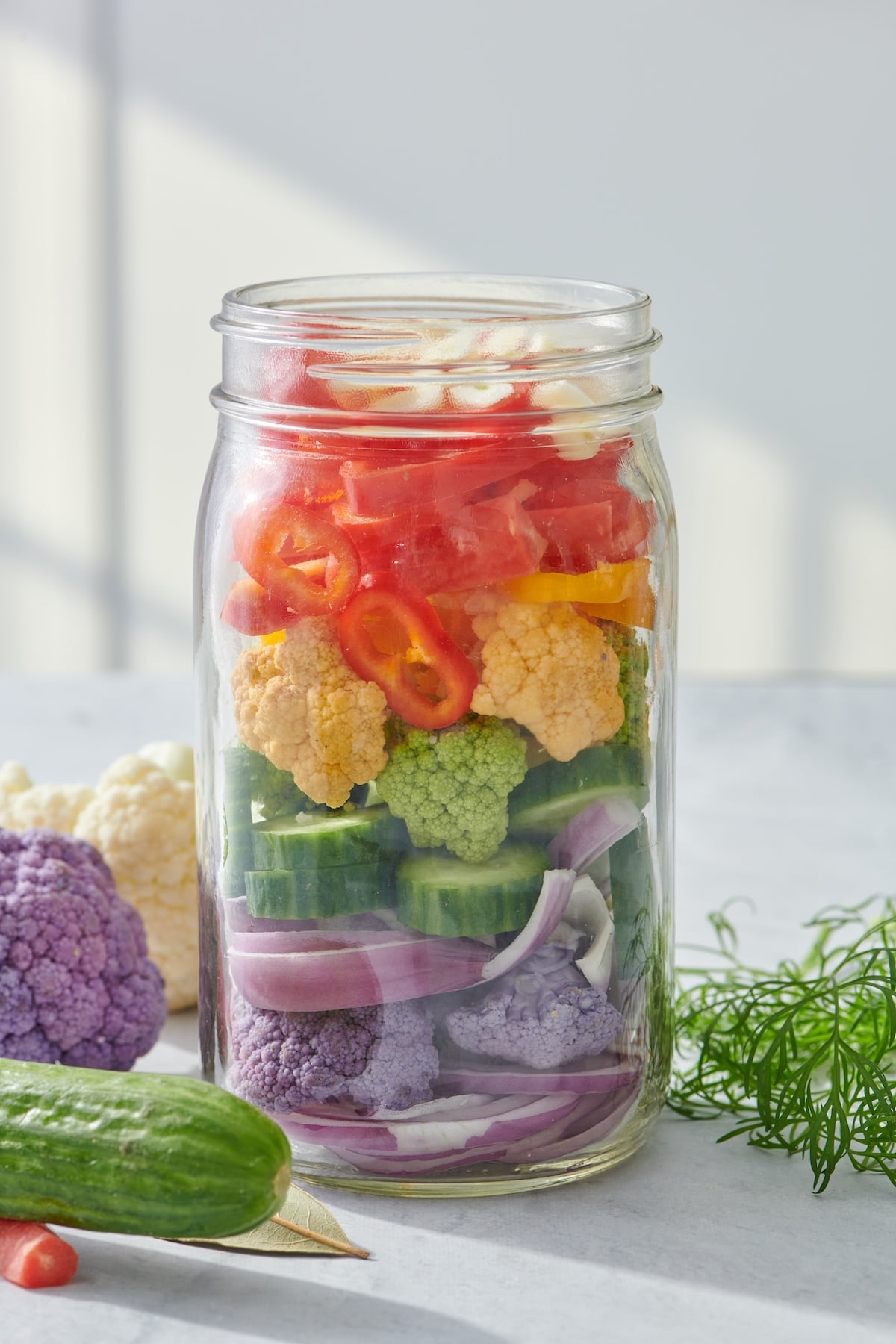 Vegetables in a mason jar ready to pickle.