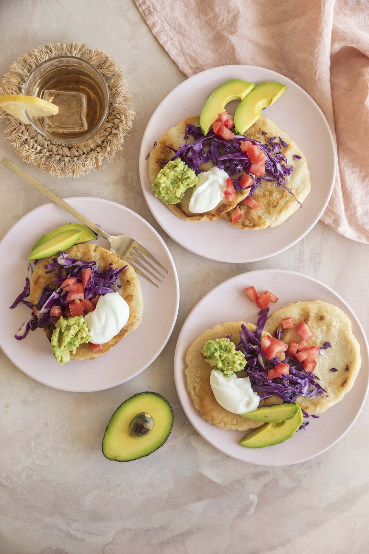 Three separate plates with servings of pupusas on each.