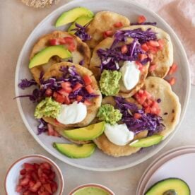 Pupusas with toppings on a plate.