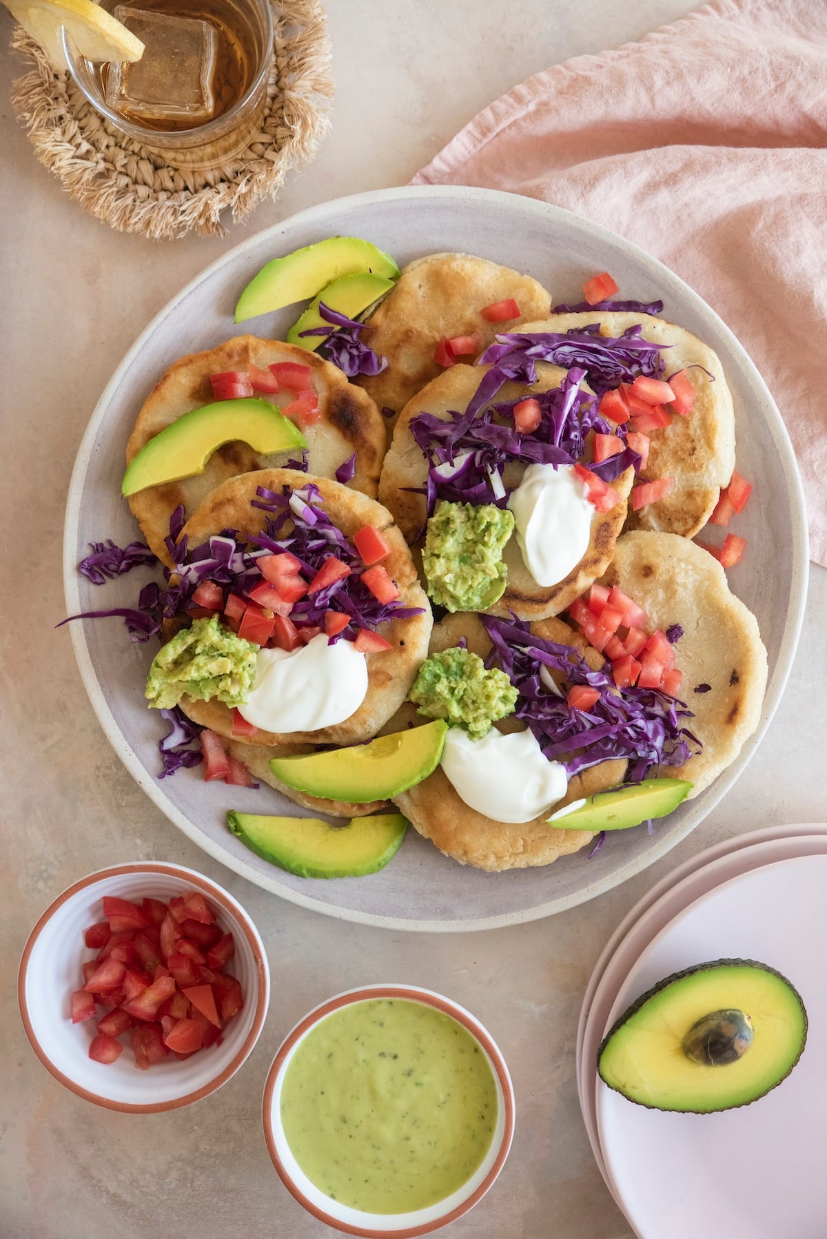 Pupusas with toppings on a plate.