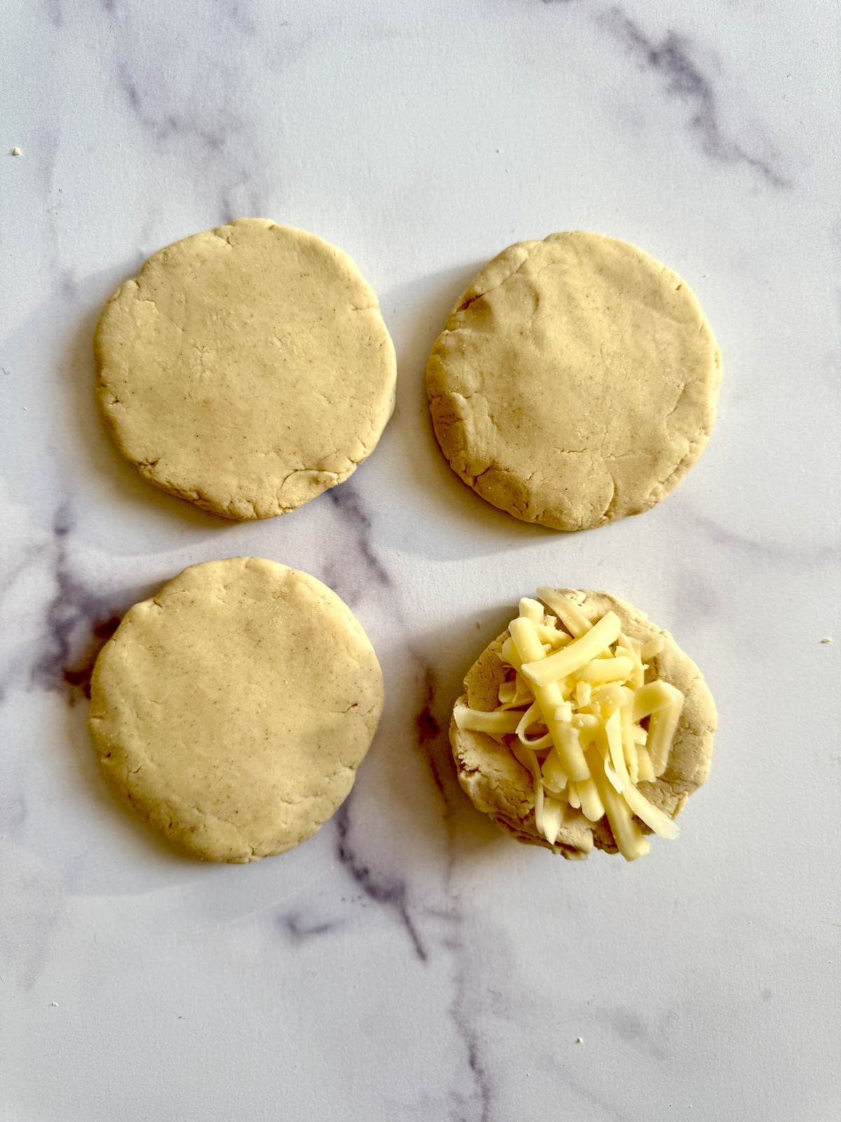 Pupusas shaped and ready to cook.