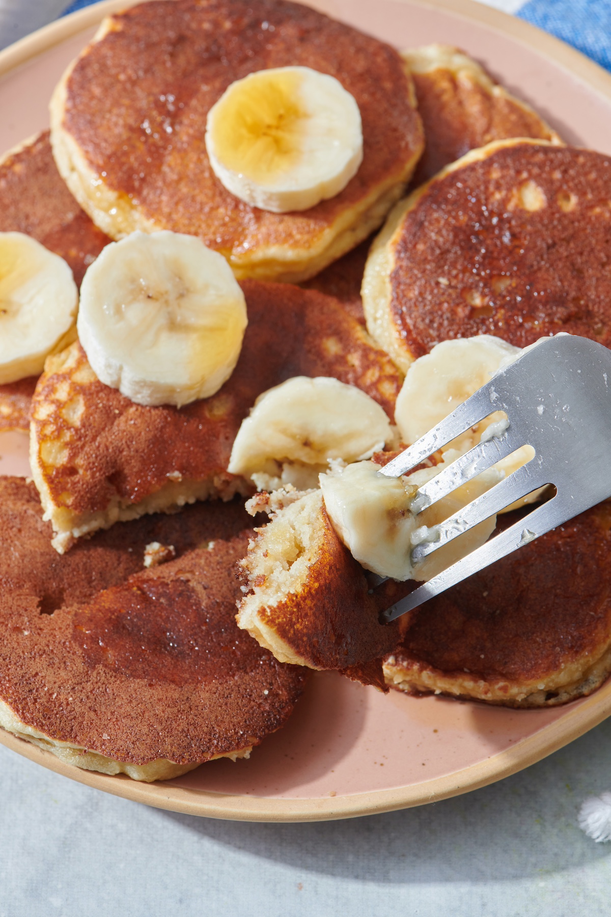 Fork with bite of almond flour banana pancake on it.
