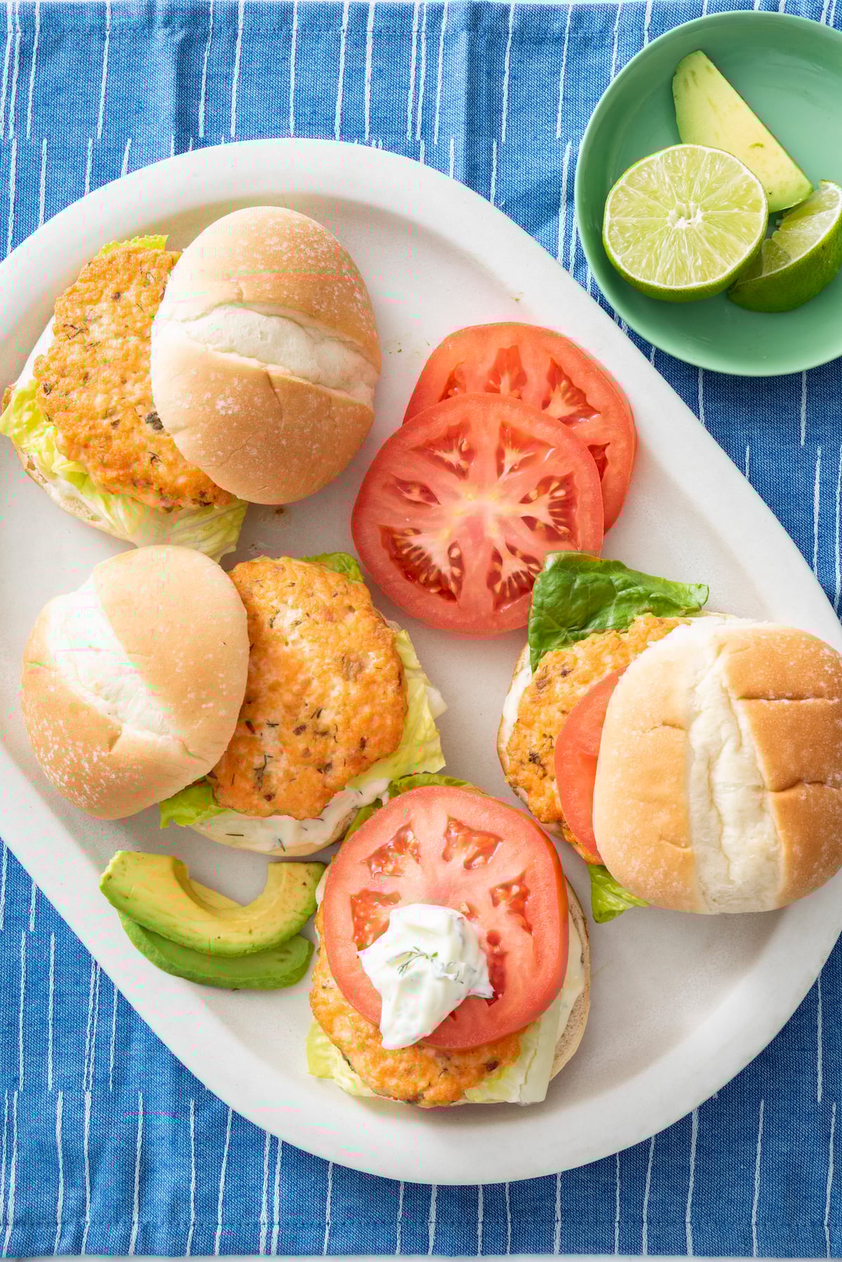 Salmon burgers on a serving platter.