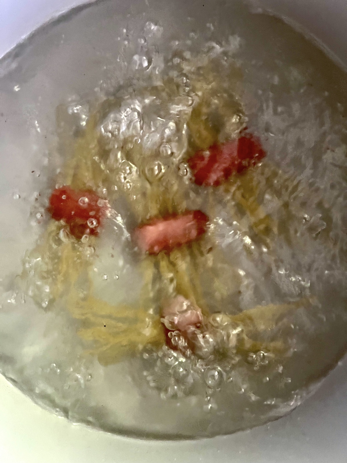 Freaky franks boiling in pot.