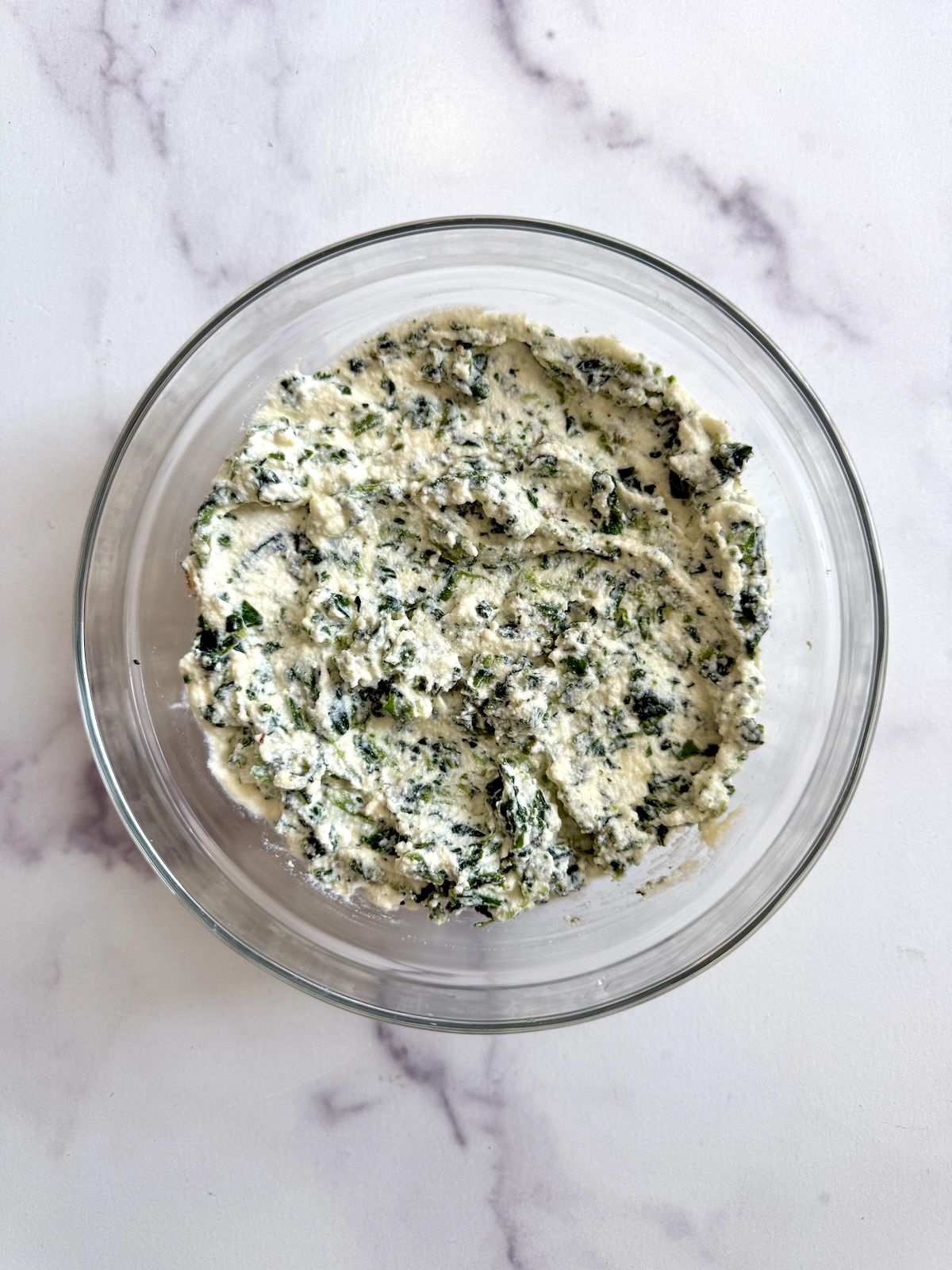 Lasagna rolls filling in a bowl.