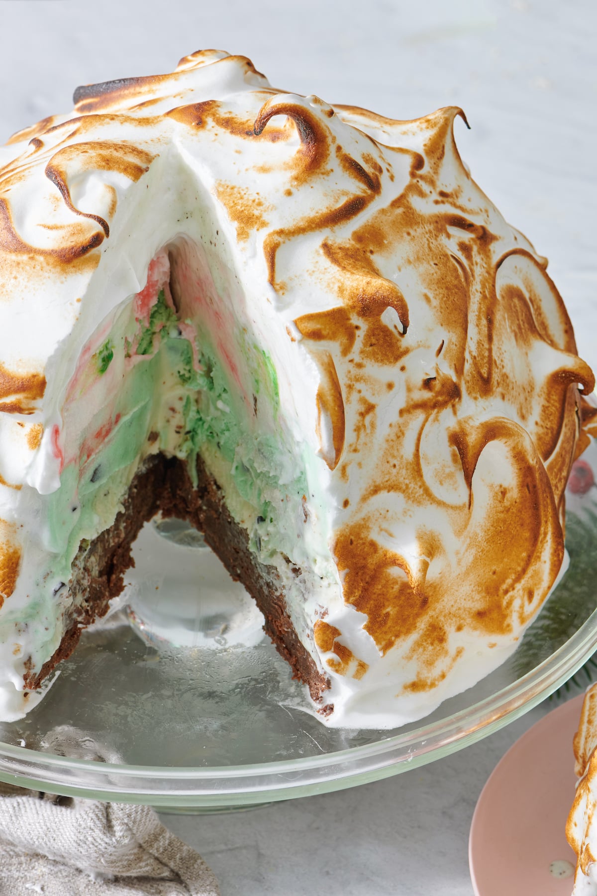 Holiday Baked Alaska with a view of the layers inside the dessert.