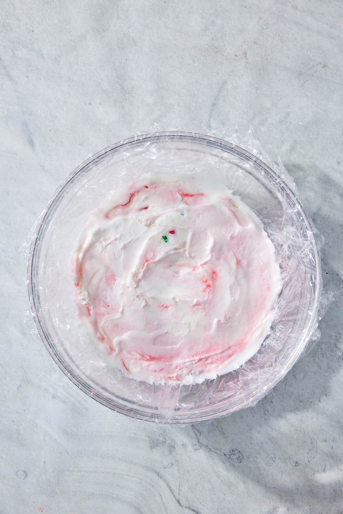 Peppermint ice cream smoothed into a later in a mixing bowl.