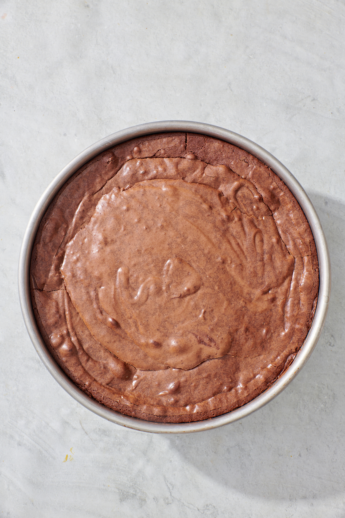 Cooked brownie in a cake pan.