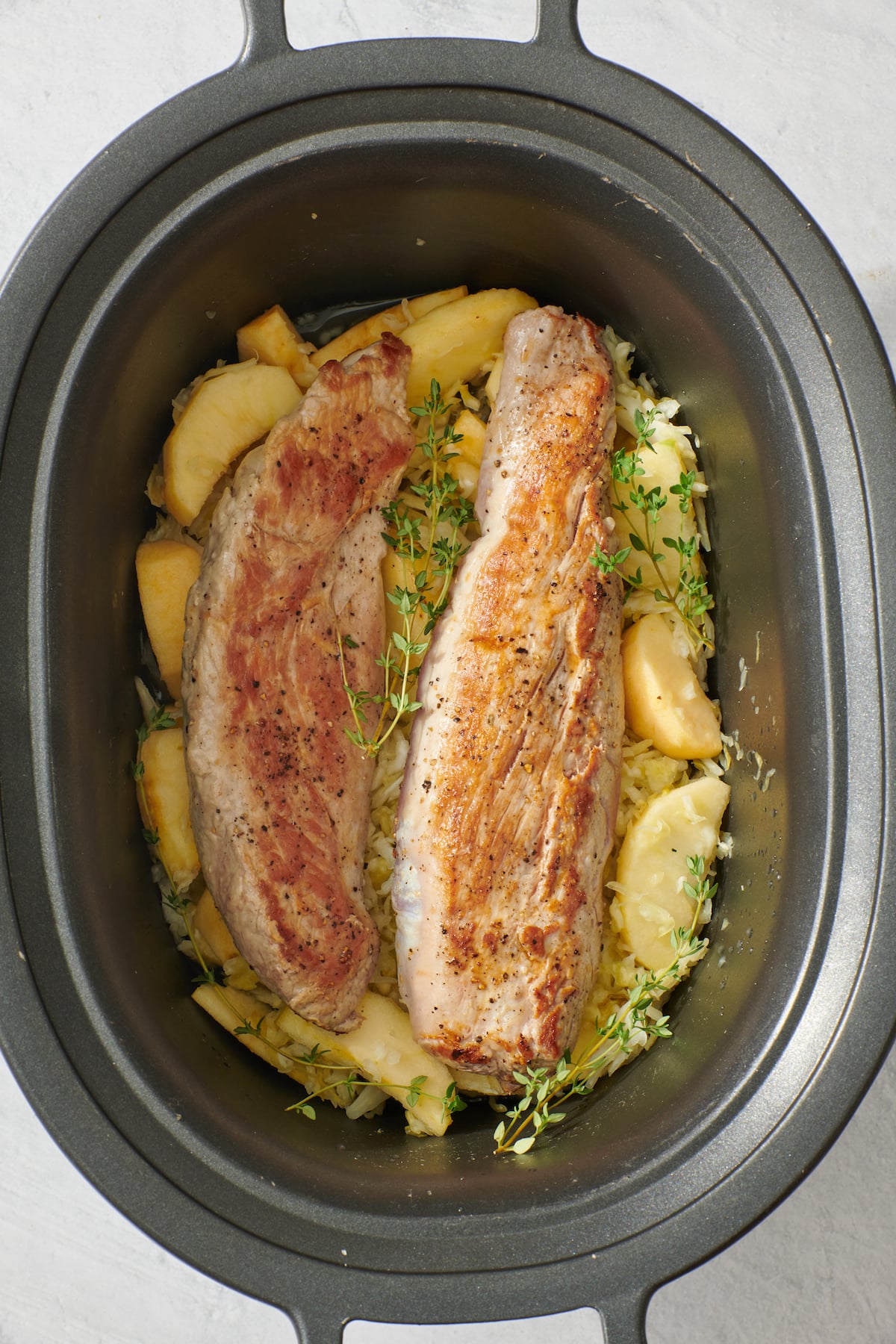 Seared Pork Tenderloin with Apples and Sauerkraut in slow cooker.