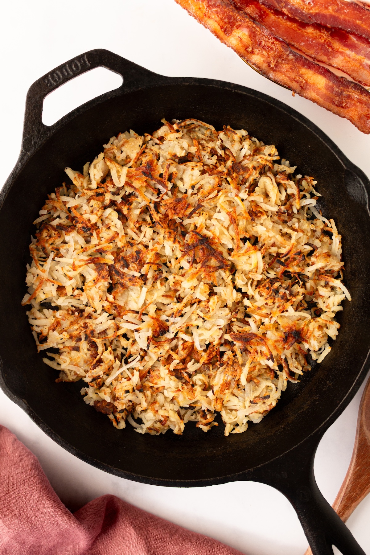 Crispy hash brown potatoes in a cast iron skilet.