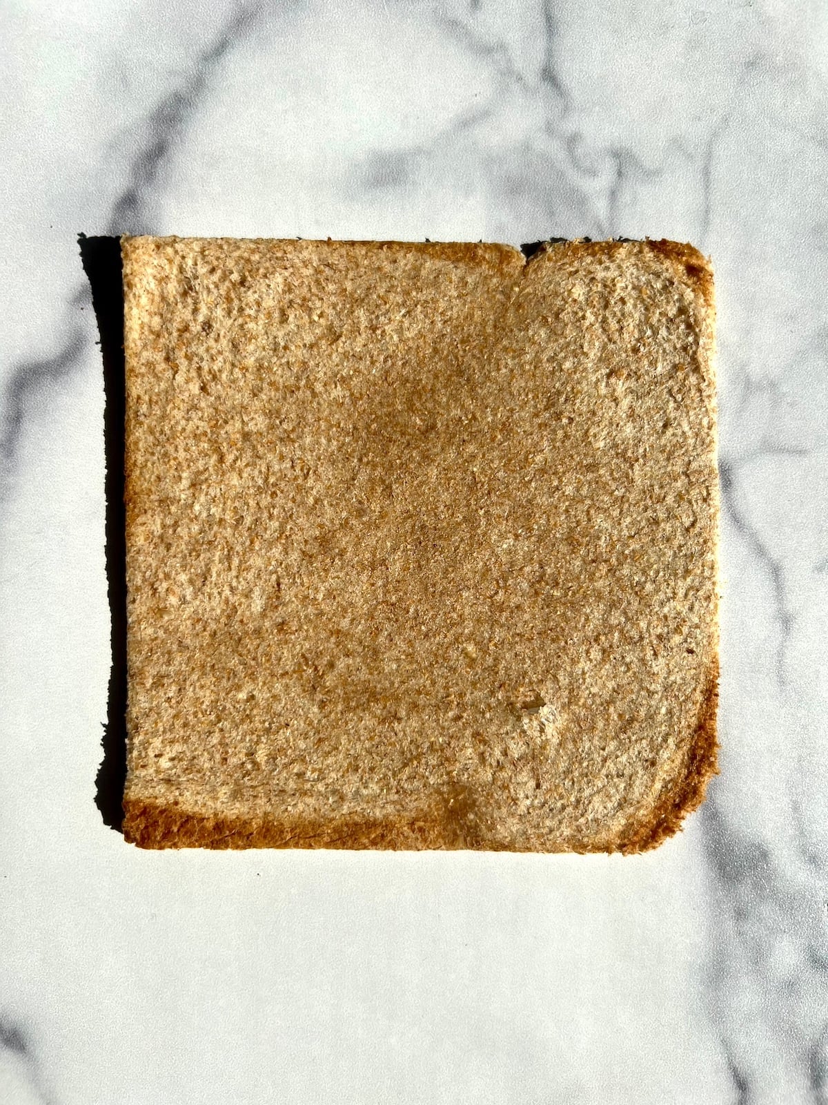 Flattened piece of sandwich bread.