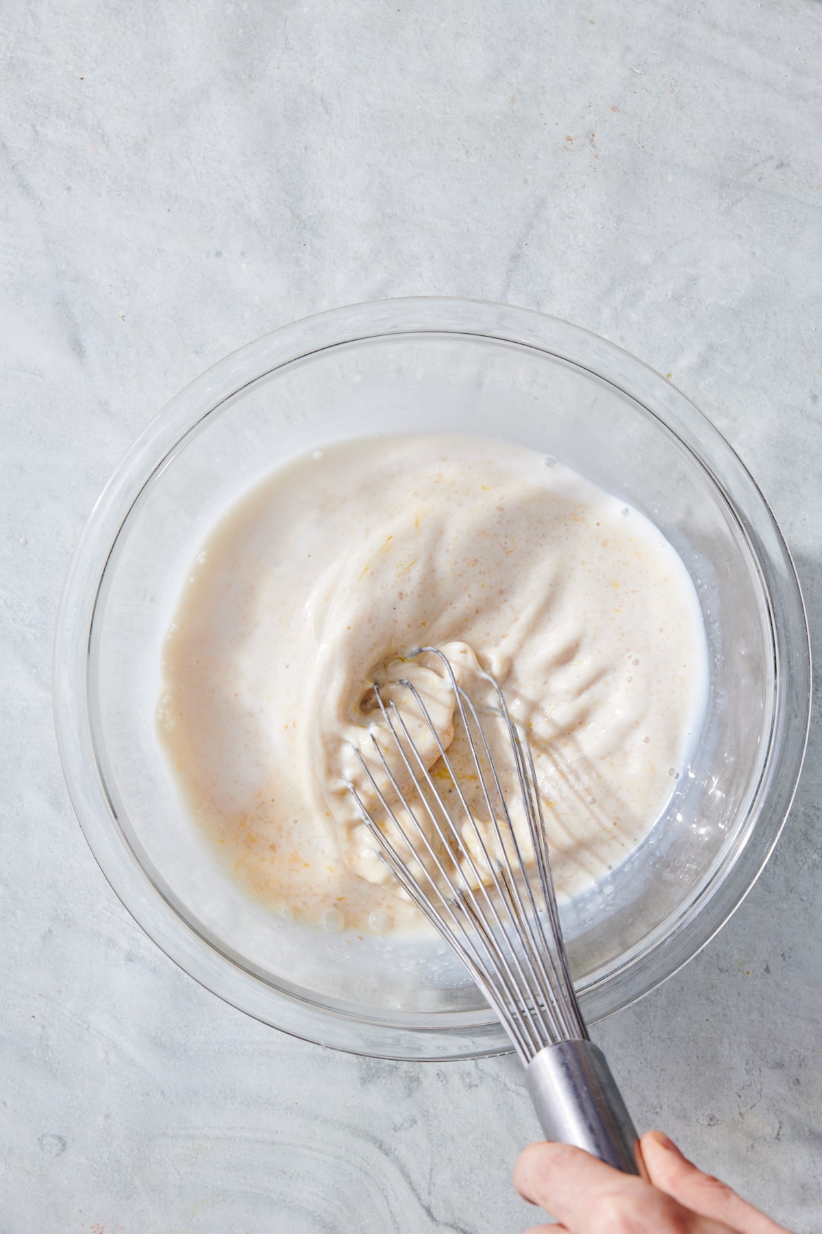 Wet ingredients being mixed with whisk.