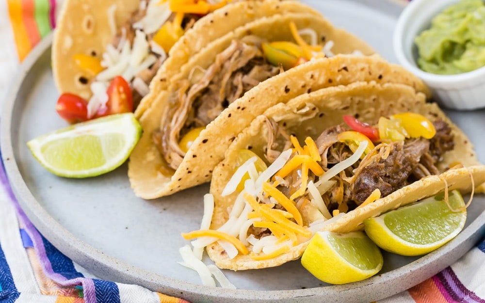 Pulled pork tacos on a plate.
