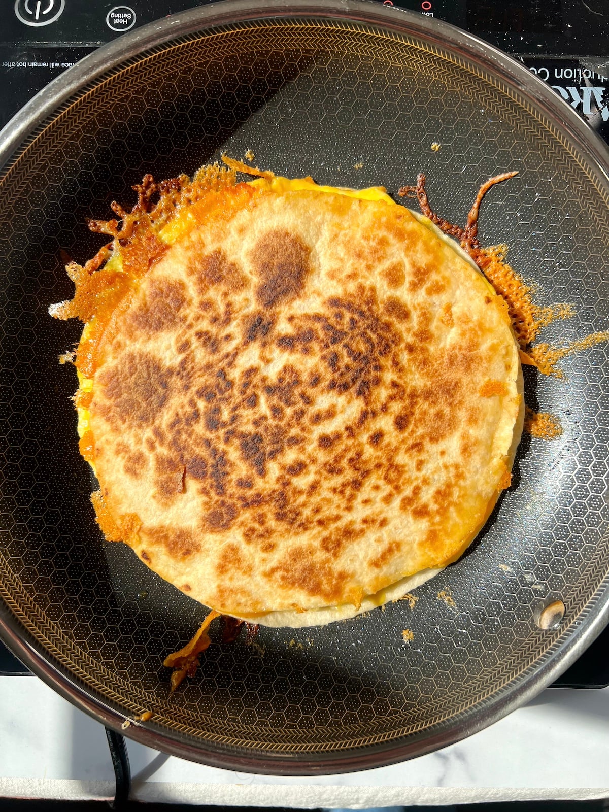 Breakfast quesadilla in pan.