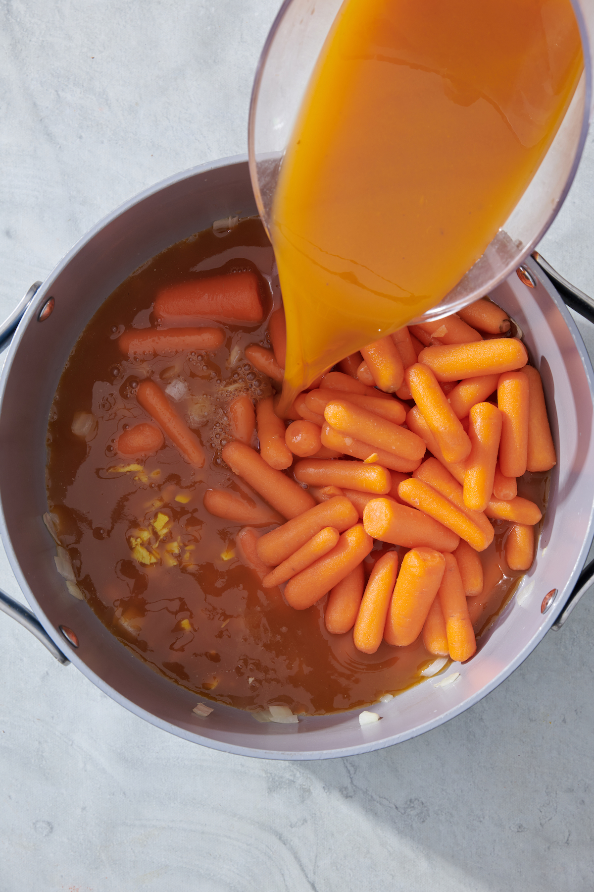 adding ingredients to stock pot