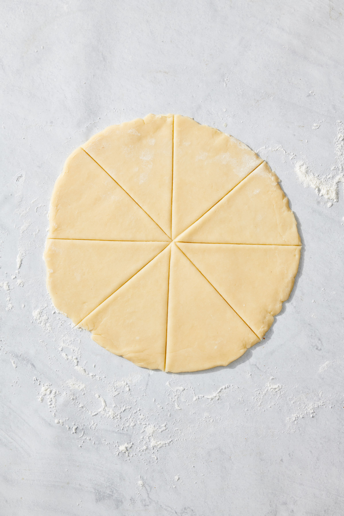 Dough rolled into circle shape and cut into 8 wedges.