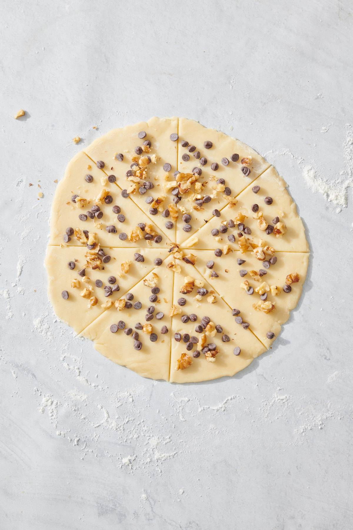 Chocolate chips and chopped walnuts on rugelach dough before rolling.