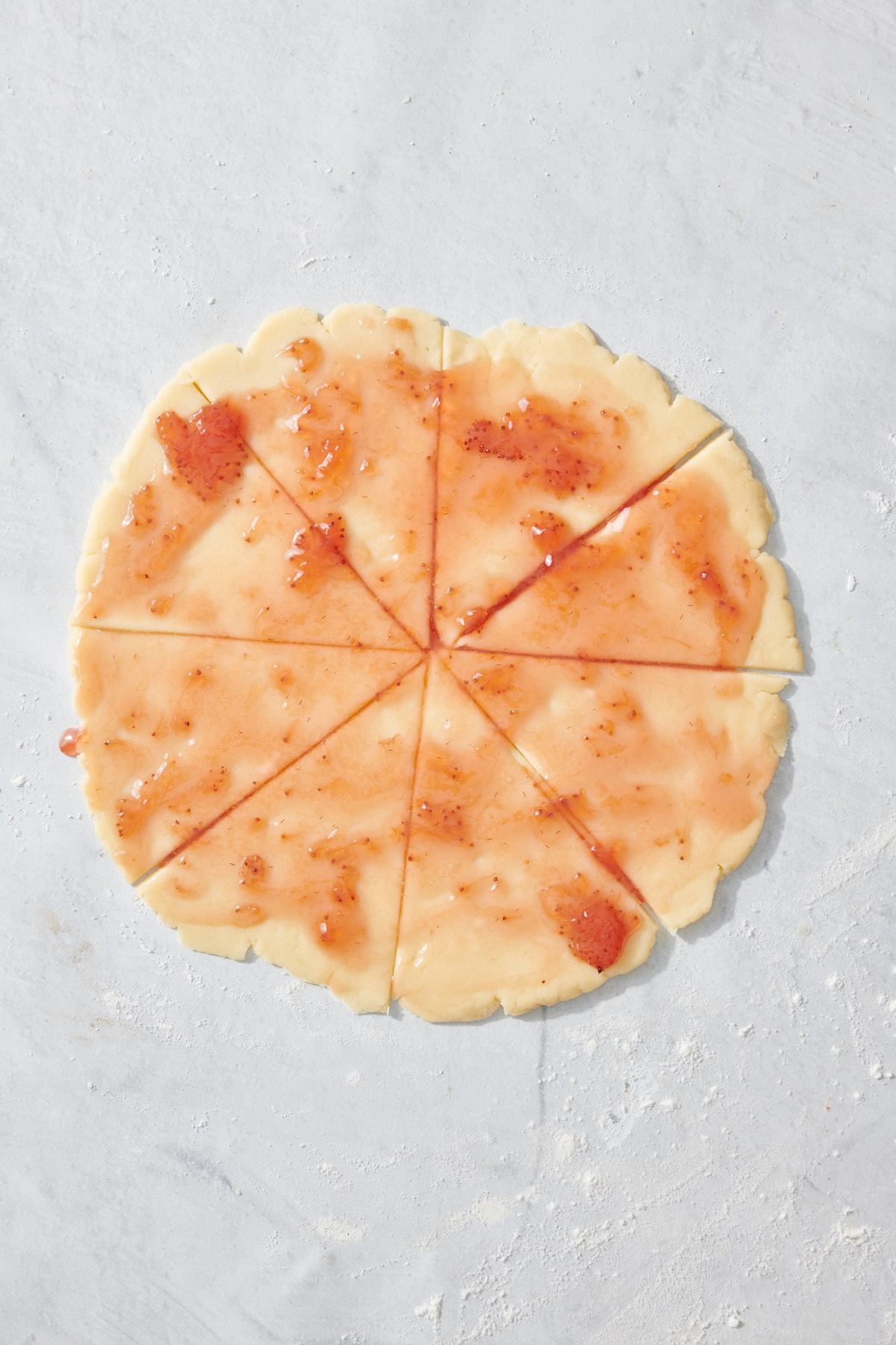 Fruit preserves spread on rugelach dough before rolling.