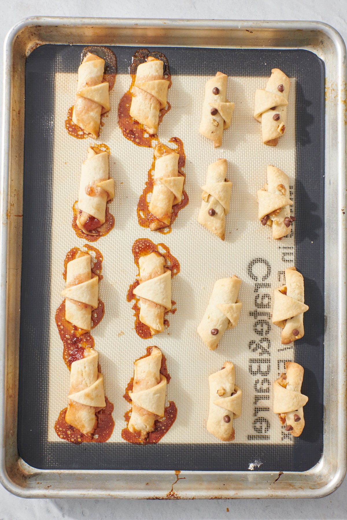 Baked rugelach on baking sheet.