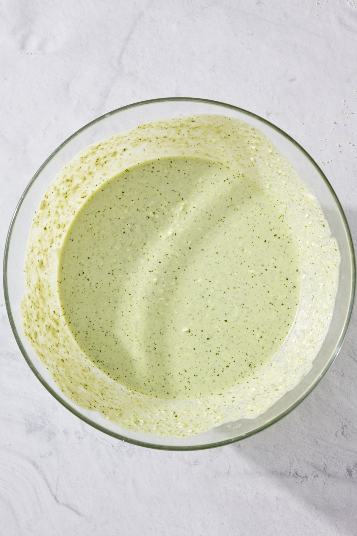 Basil Pesto Cheesecake Mixture in a bowl.