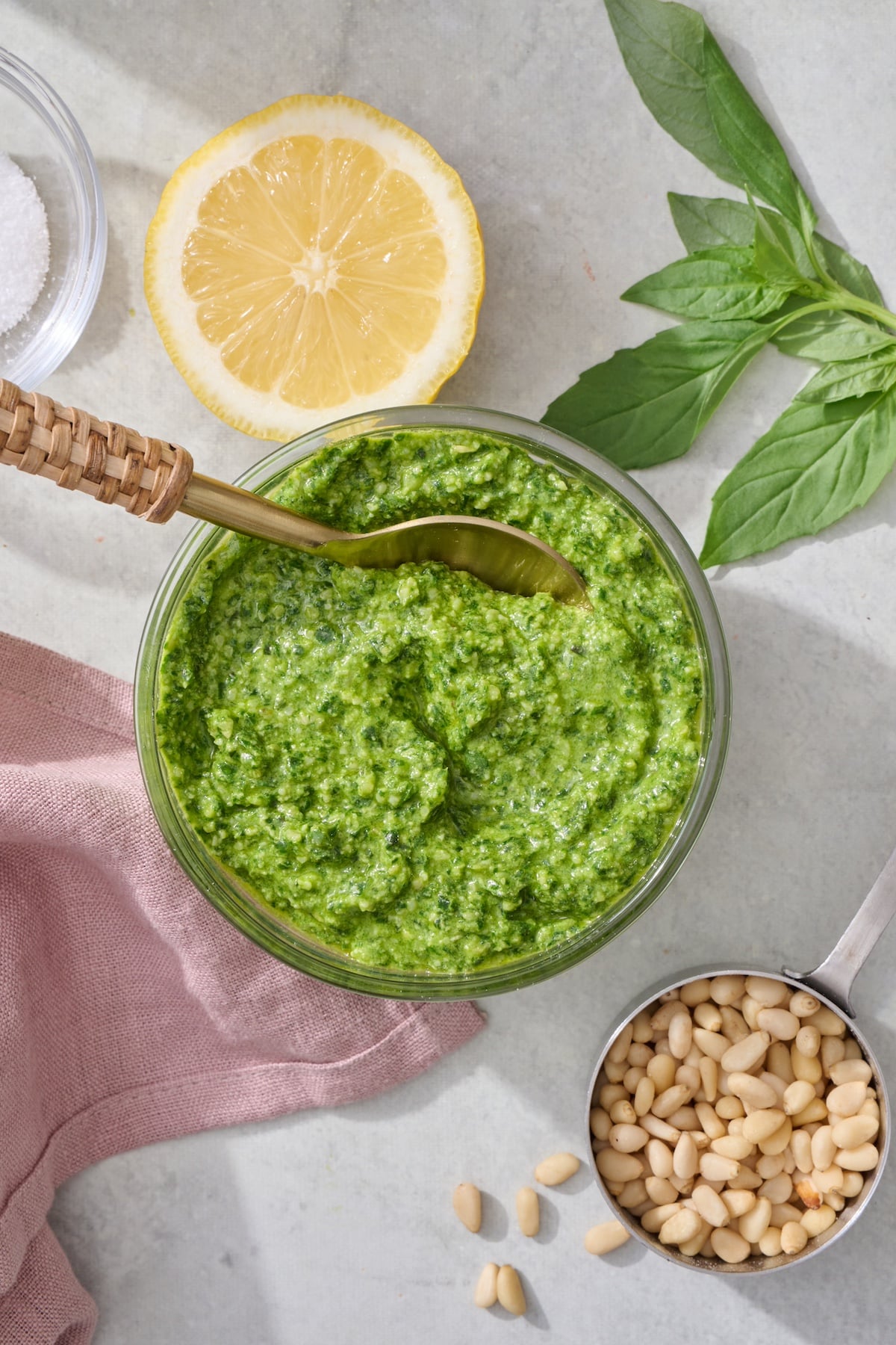 Basil pesto in bowl with spoon.