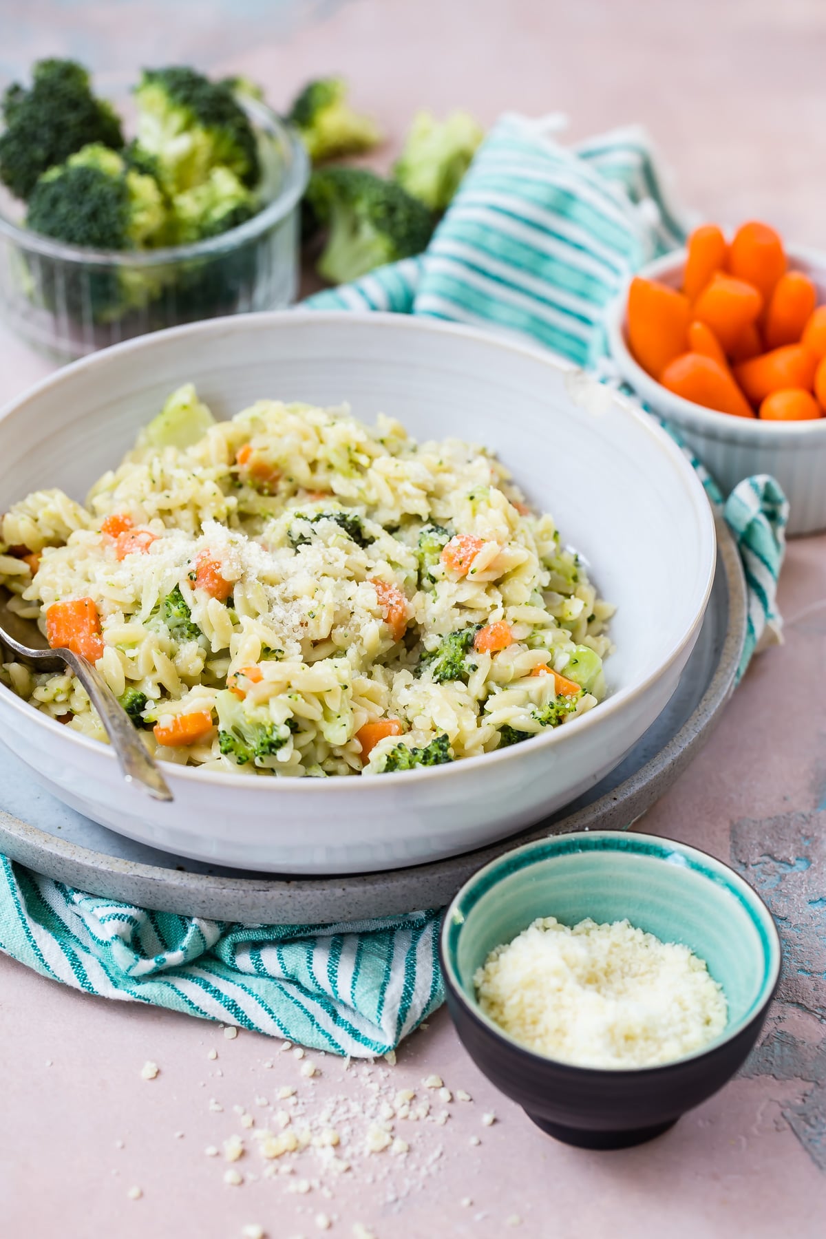Carrot broccoli and cheese orzo in a bowl.