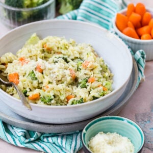 Carrot broccoli and cheese orzo in a serving bowl.
