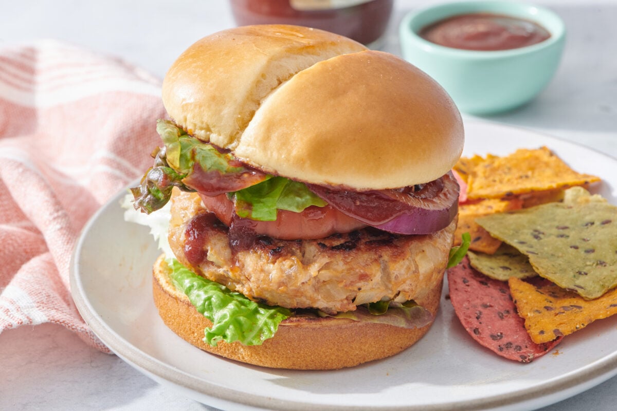 burger on a plate with side of chips