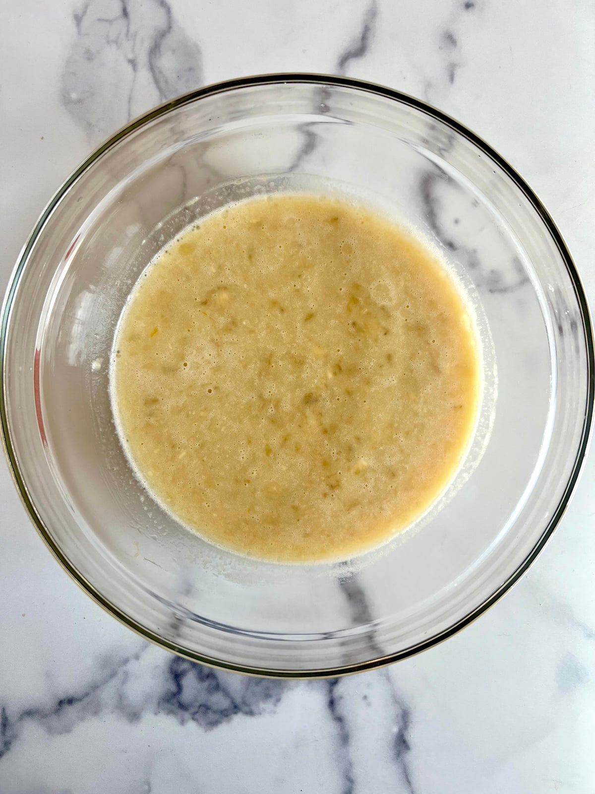 Banana chocolate chiip muffins wet ingredients in a bowl.