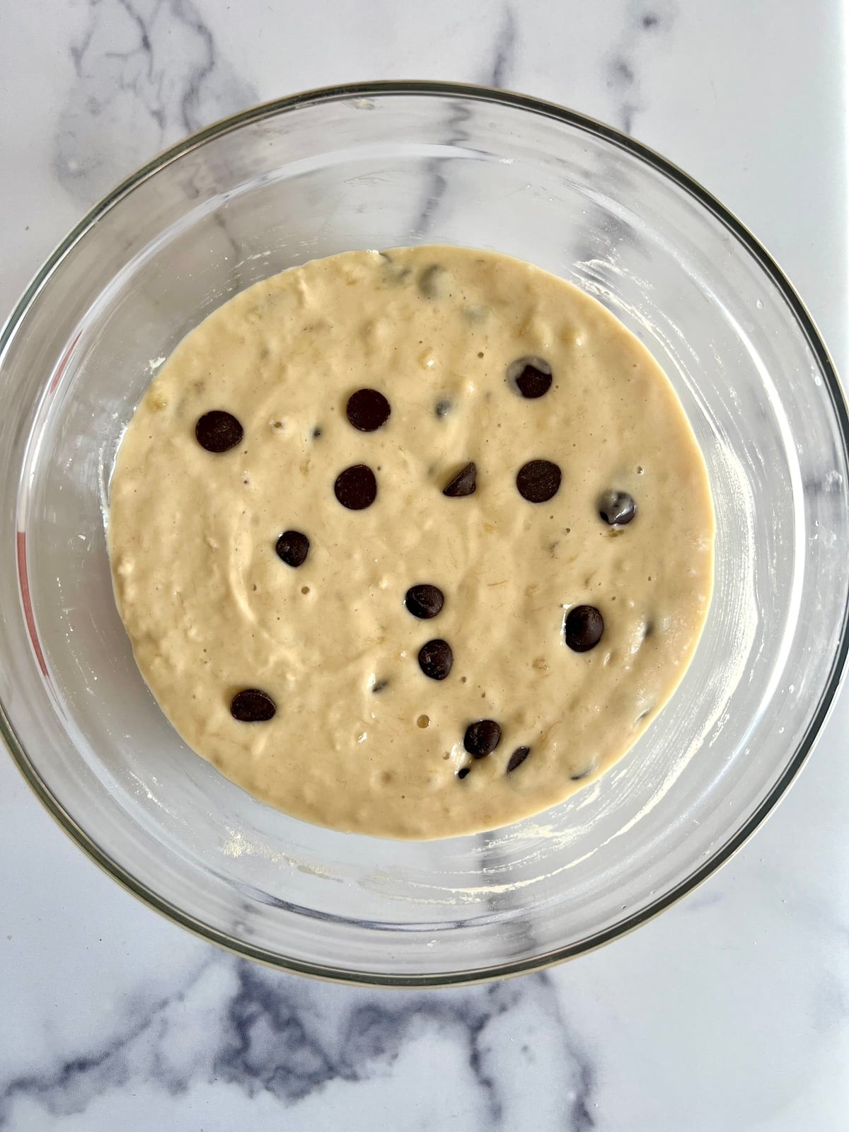 Banana chocolate chip muffin batter in a bowl.