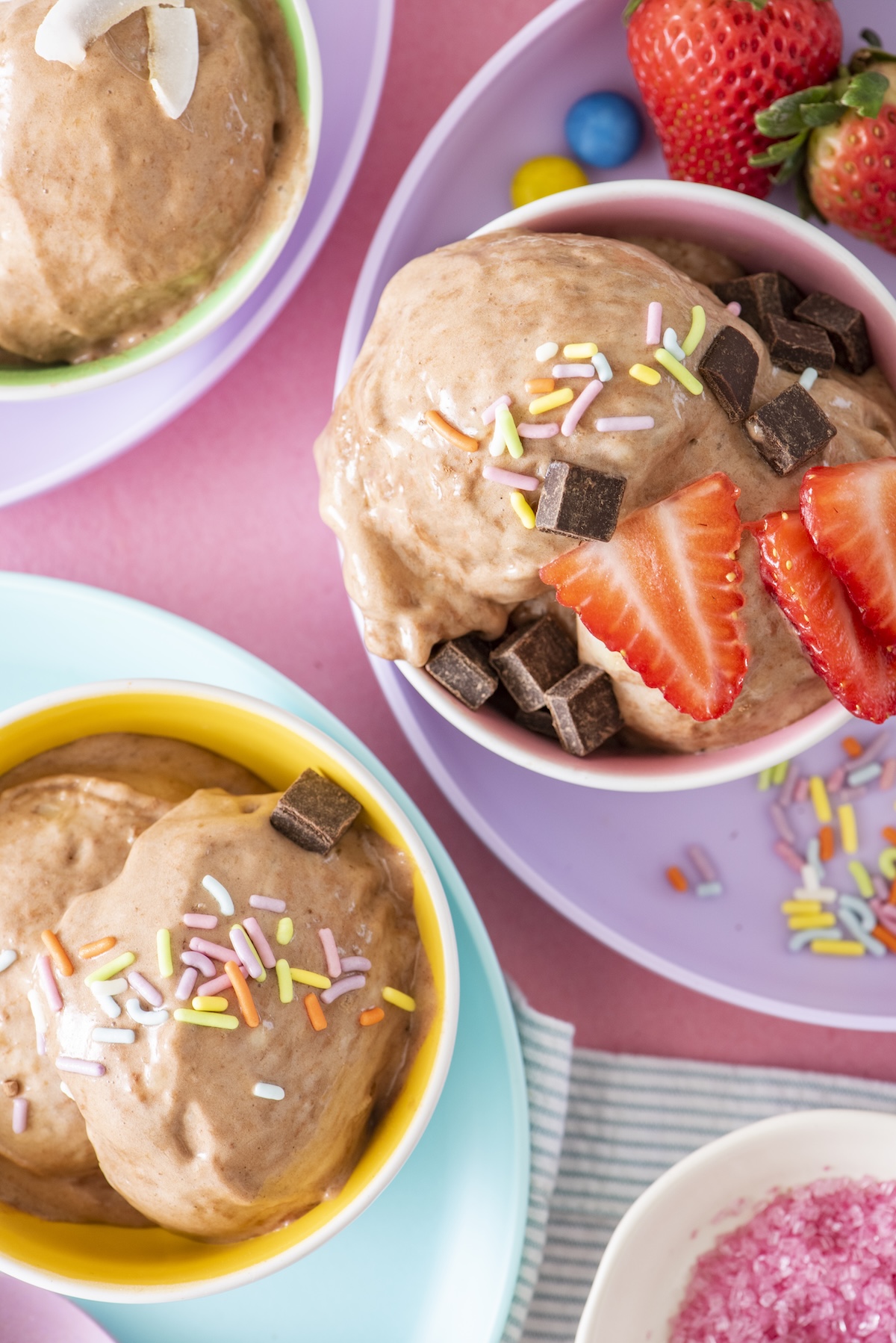 Chocolate banana ice cream topped with strawberries.