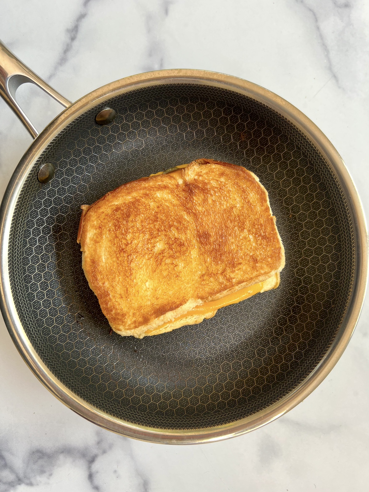 Pickle grilled cheese on saute pan.