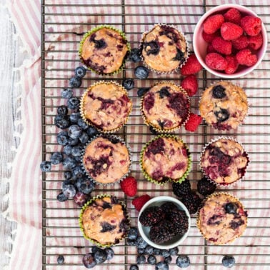 Very berry muffins on a cooling rack.