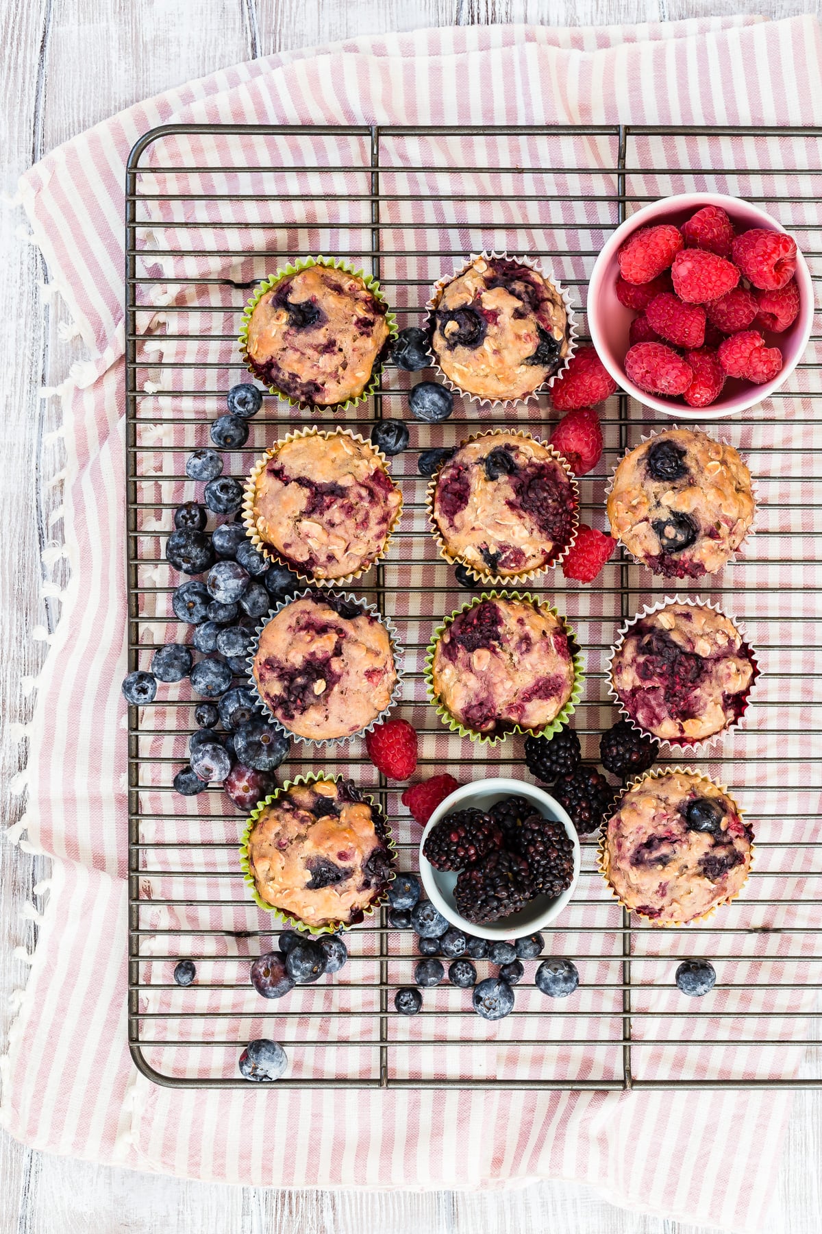 Very berry muffins on a cooling rack.