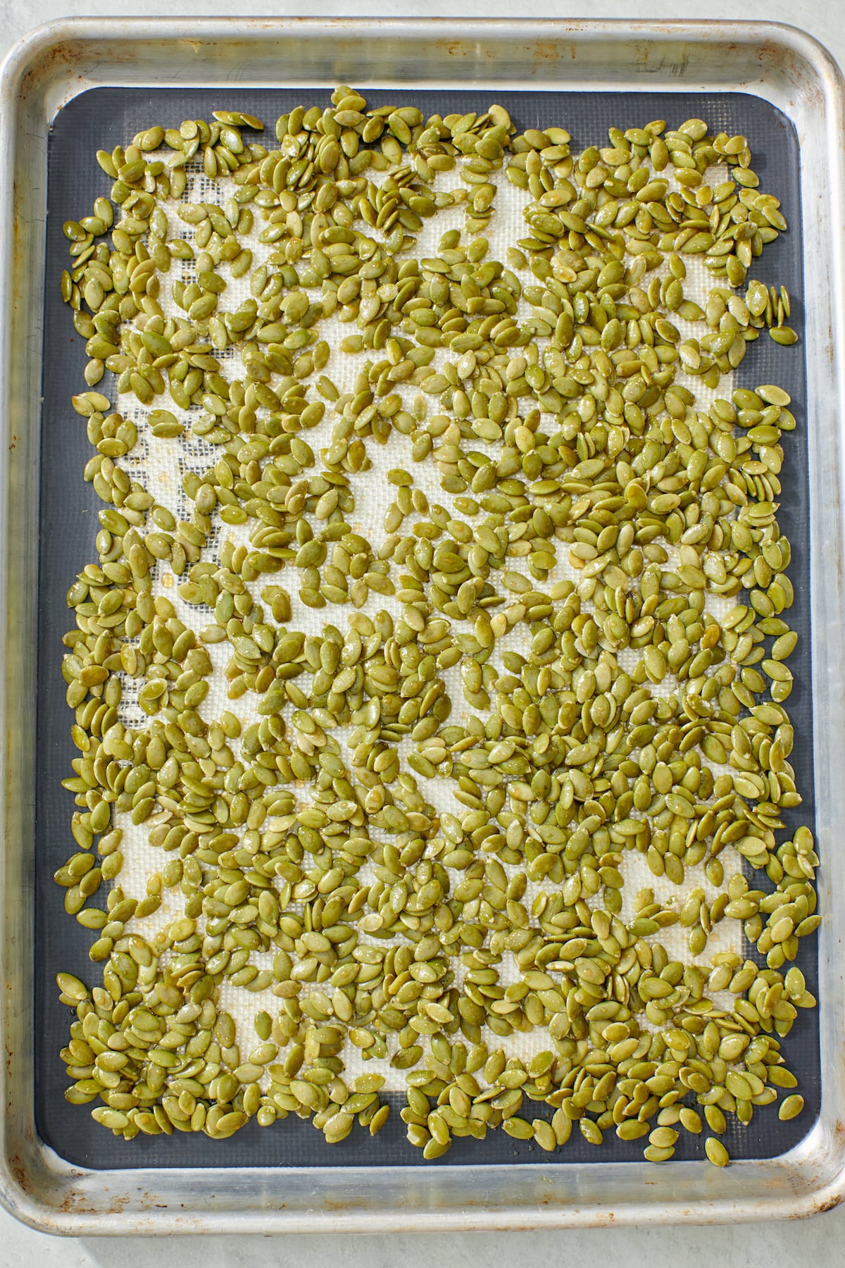Pumpkin Seeds on baking sheet before roasting.