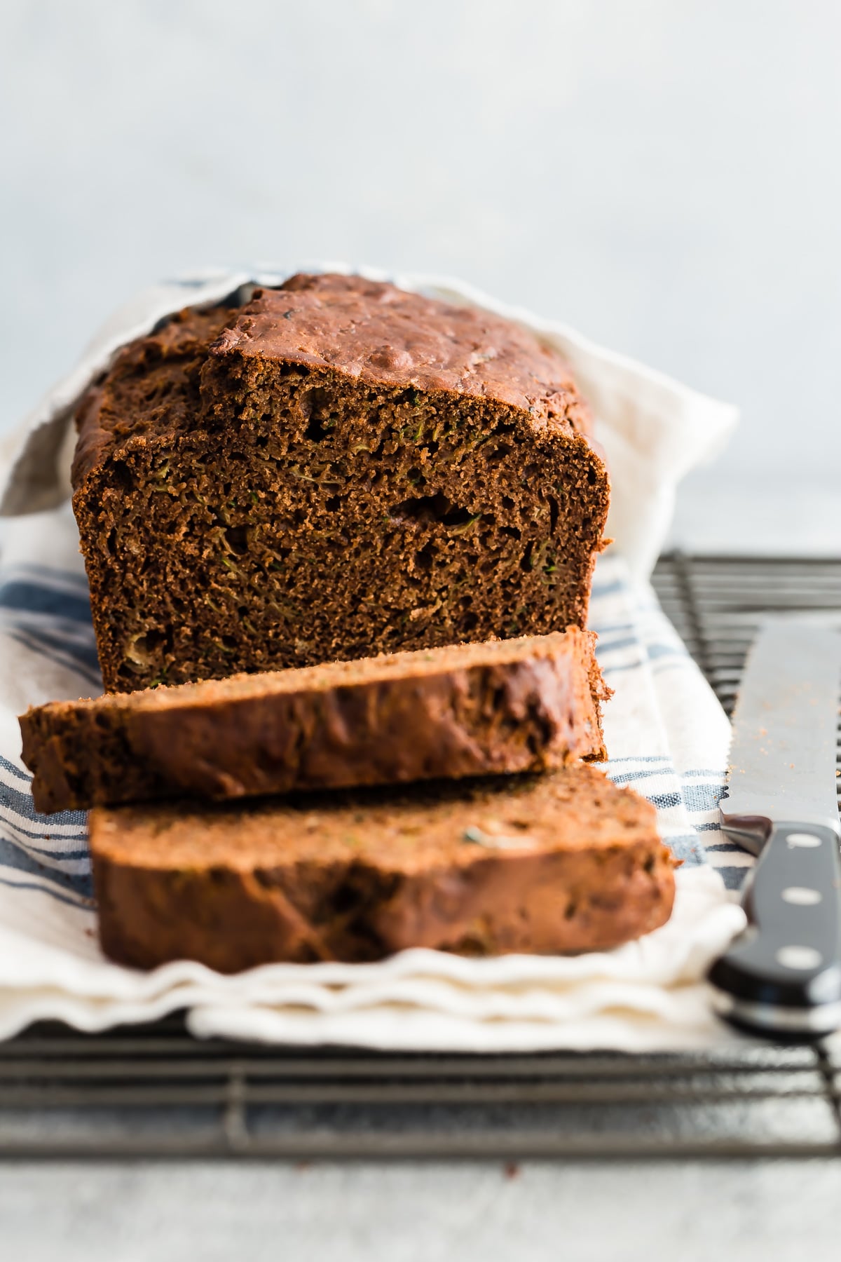 Chocolate zucchini bread sliced on cooling rack.